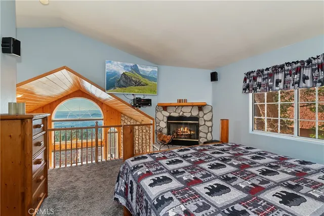 a bedroom with a bed and a fireplace