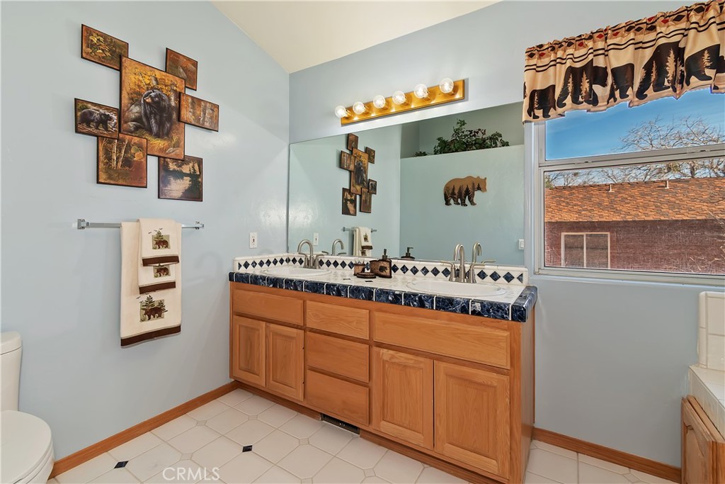 2477 Spring Oak Drive Running Springs, CA 92382 - Photo 31 of 51 a bathroom with a sink and a mirror