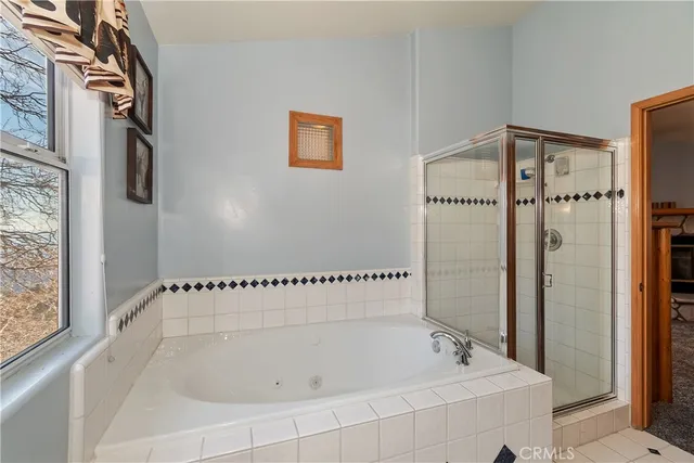 a bathroom with a bathtub and a shower