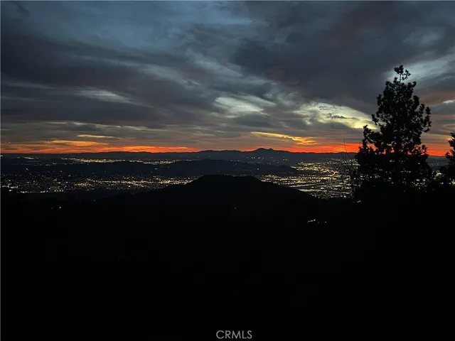 a view of sunset and covered with trees