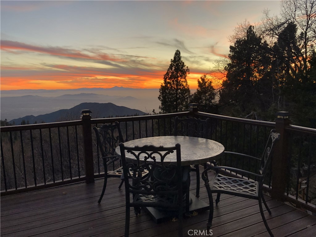 2477 Spring Oak Drive Running Springs, CA 92382 - Photo 7 of 51 a view of a chairs and table on the deck