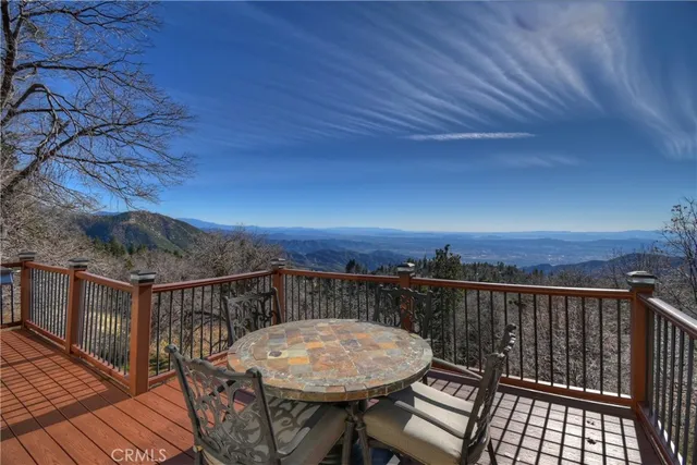 a view of a roof deck with chair and wooden floor