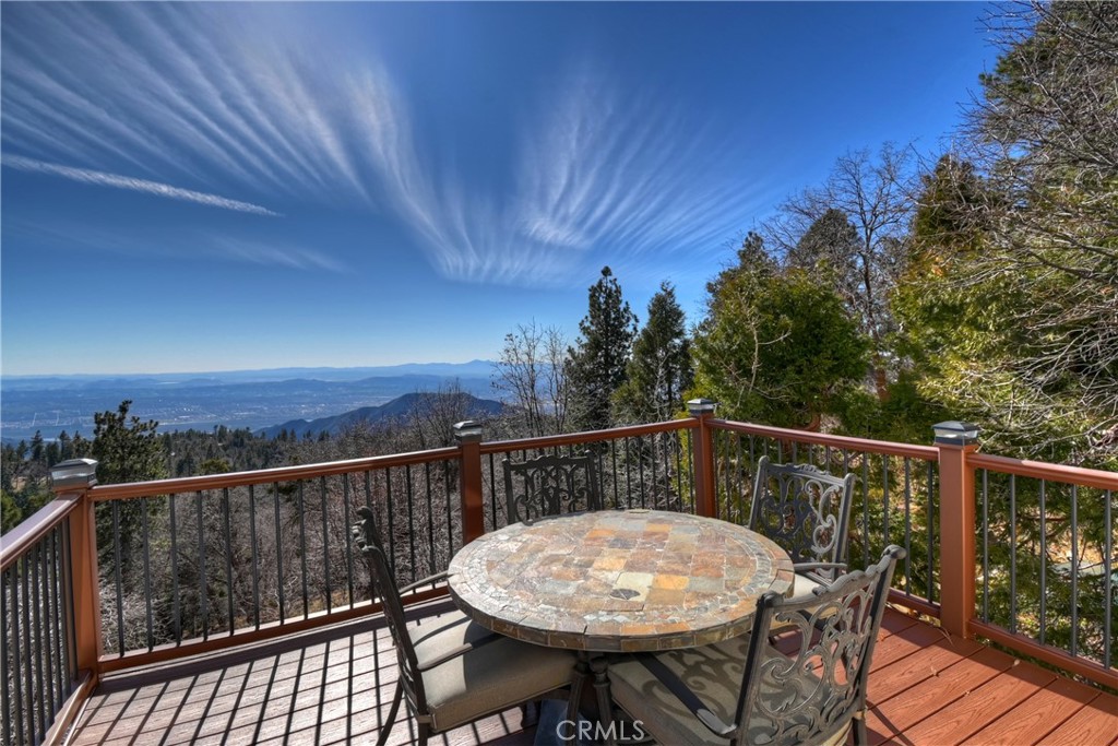 2477 Spring Oak Drive Running Springs, CA 92382 - Photo 9 of 51 a view of a roof deck with chair and wooden floor