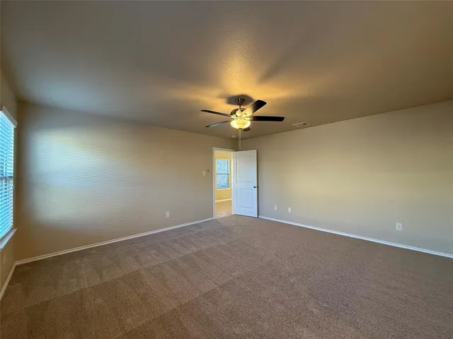 a view of a livingroom with a ceiling fan and window
