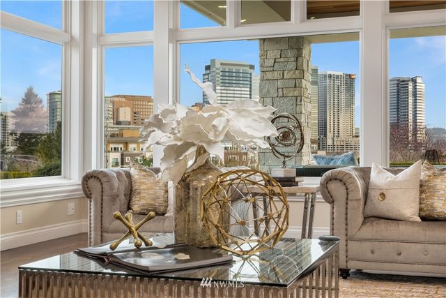 a living room with furniture and a floor to ceiling window
