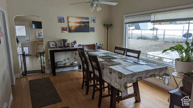 1341 East Crk Road Sandy, UT 84093 - Photo 19 of 24 Dining area featuring ceiling fan, wood finished floors, healthy amount of natural light, and arched walkways