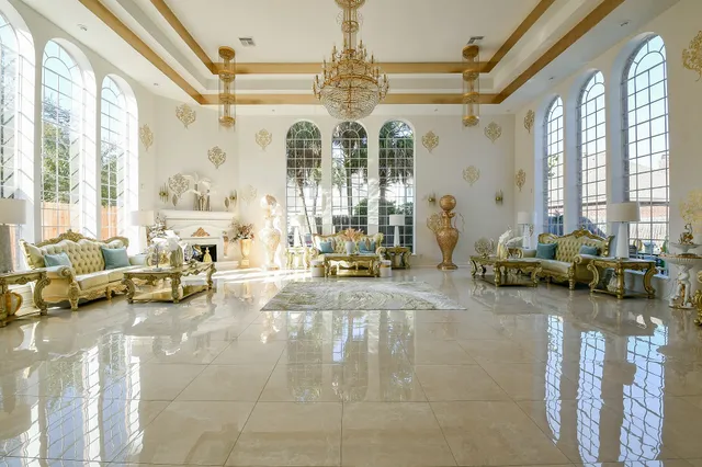 a living room with furniture and floor to ceiling windows