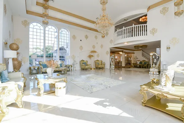 a living room with fireplace furniture and a chandelier