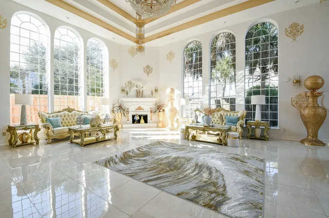 a living room with furniture and floor to ceiling windows