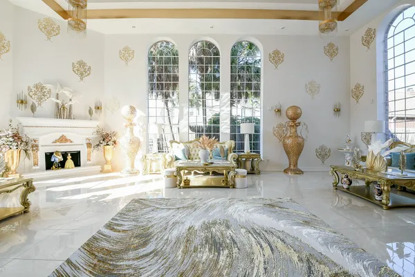 a spacious bedroom with furniture and a large window