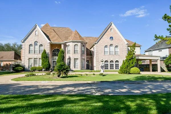 a front view of building with yard and green space
