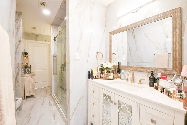 a bathroom with a sink vanity and a mirror