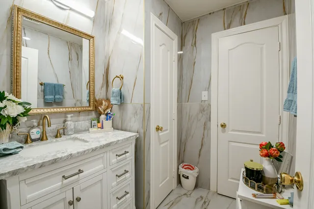 a bathroom with a granite countertop sink a vanity and a mirror