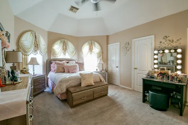 a bedroom with a bed and a chandelier