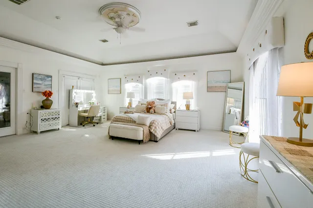 a bedroom with furniture and a chandelier