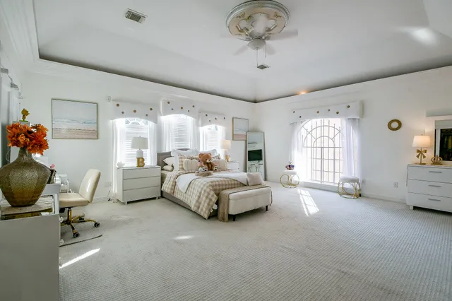 a spacious bedroom with a bed and window