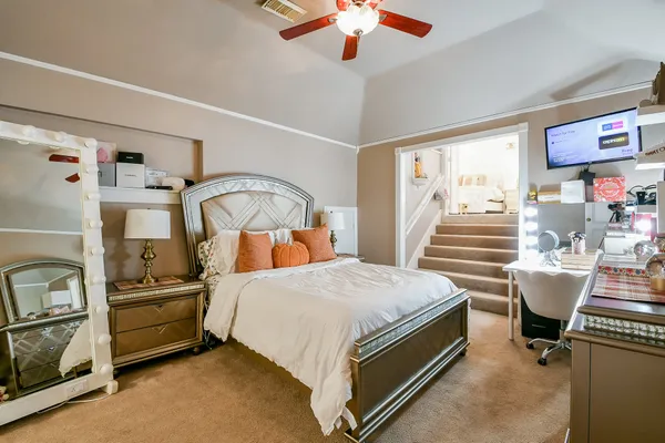 a bedroom with a bed and a chandelier