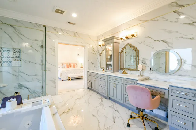 a spacious bathroom with a granite countertop sink mirror and bathtub