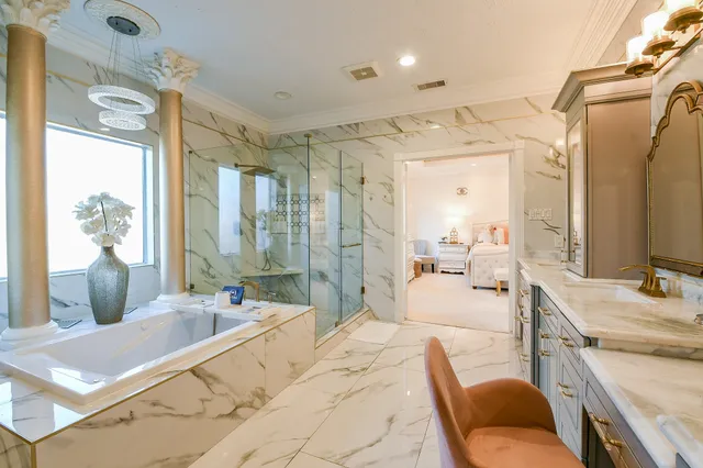 a large bedroom with a bed and glass windows