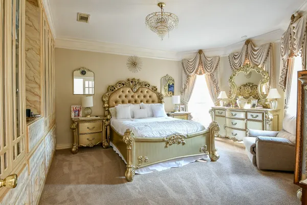 a bedroom with a bed and a chandelier