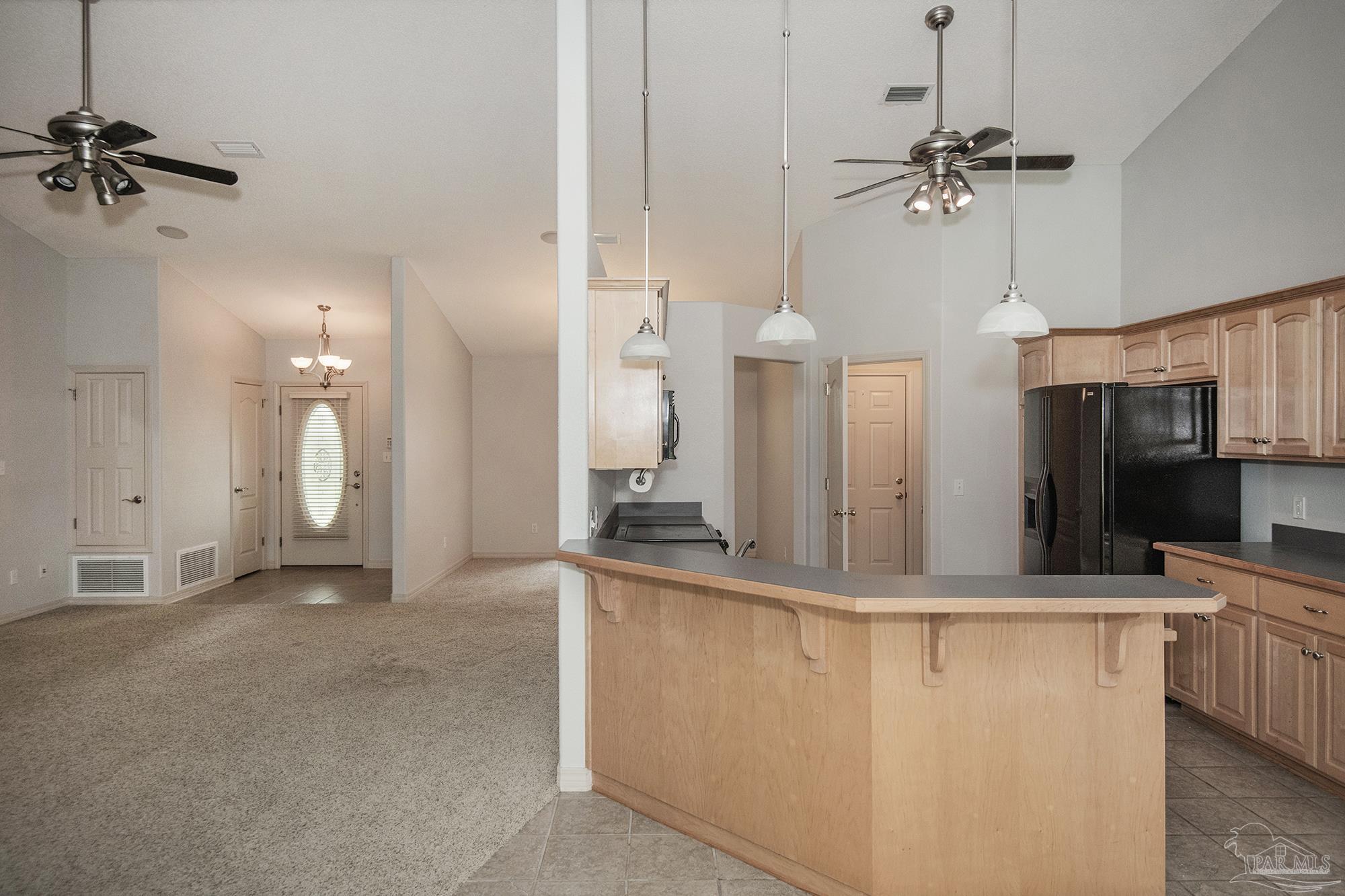 4565 South Spencer Field Road Pace, FL 32571 - Photo 11 of 49 a view of a kitchen with a sink and a refrigerator