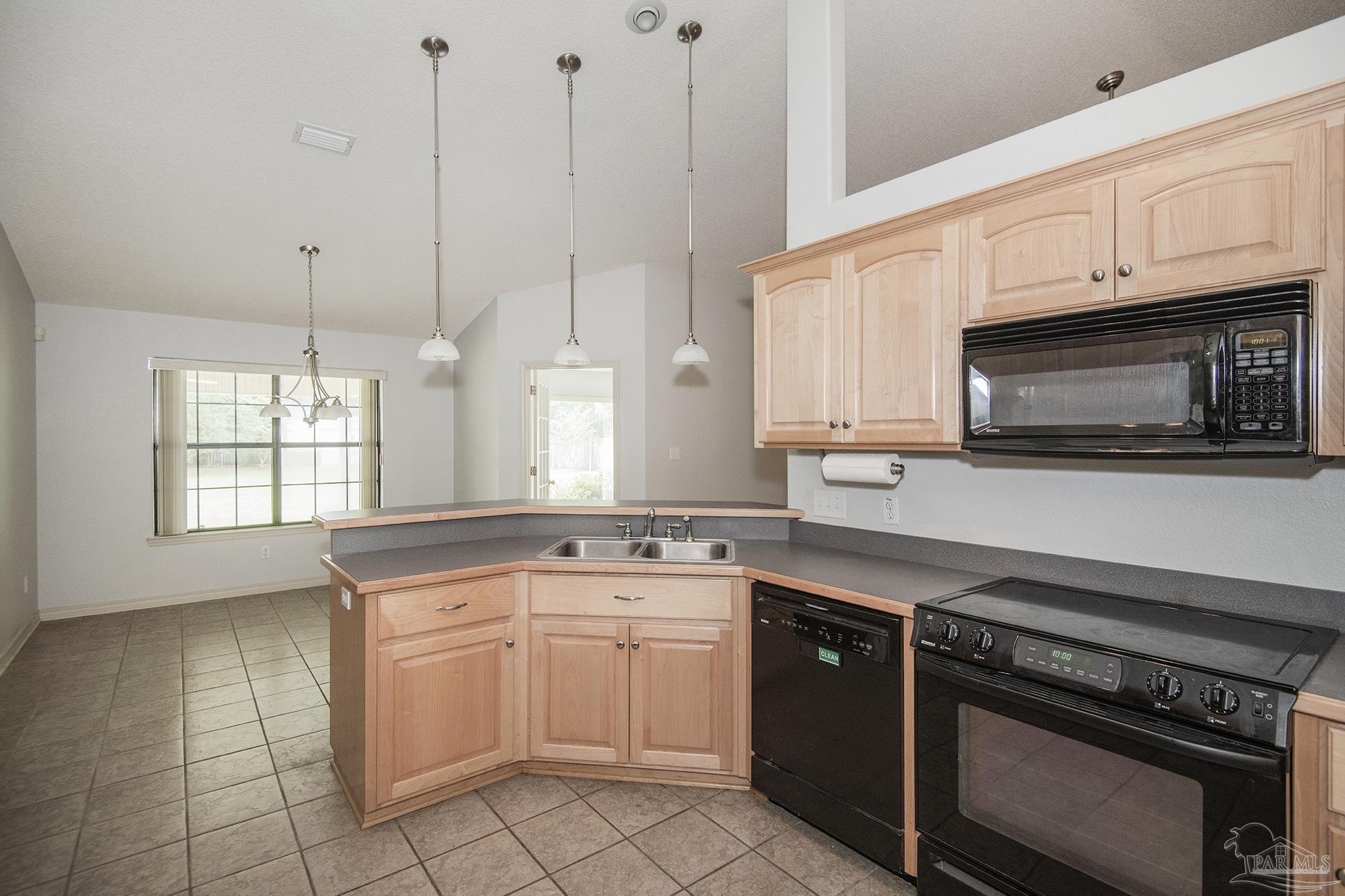 4565 South Spencer Field Road Pace, FL 32571 - Photo 18 of 49 a kitchen with a sink stove and microwave
