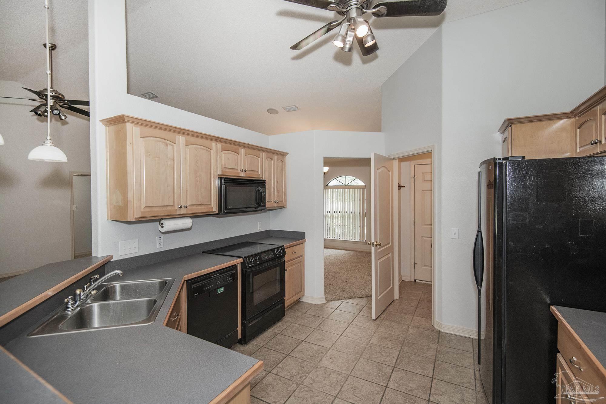 4565 South Spencer Field Road Pace, FL 32571 - Photo 19 of 49 a kitchen with stainless steel appliances granite countertop a refrigerator and a sink