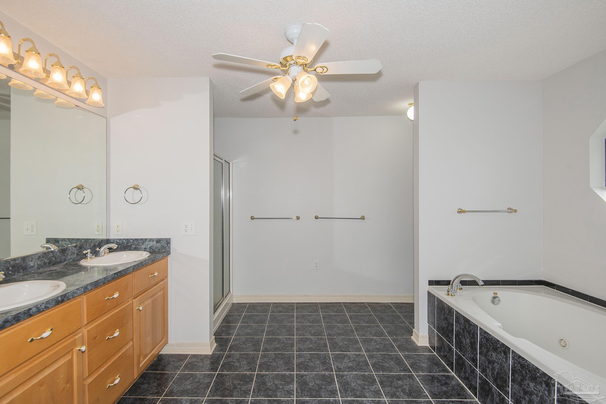 4565 South Spencer Field Road Pace, FL 32571 - Photo 23 of 49 a bathroom with a granite countertop sink a large mirror and a shower