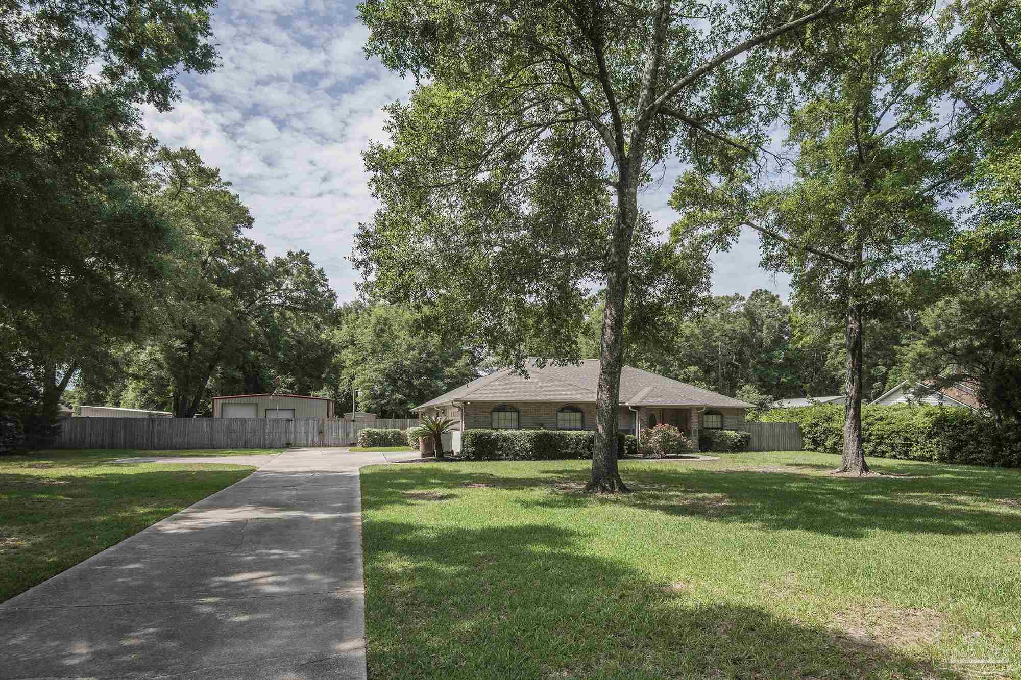4565 South Spencer Field Road Pace, FL 32571 - Photo 3 of 49 a view of a house with a yard