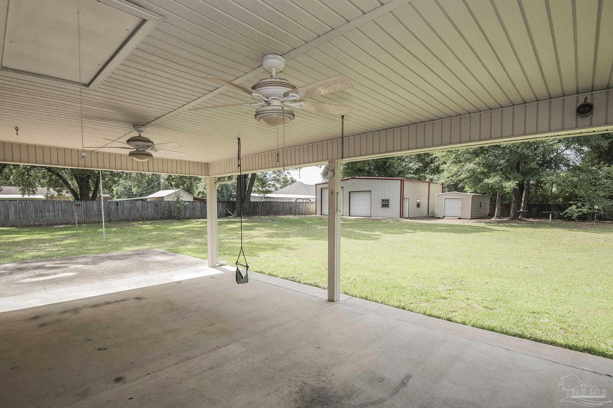 4565 South Spencer Field Road Pace, FL 32571 - Photo 32 of 49 a view of a house with backyard porch and sitting area