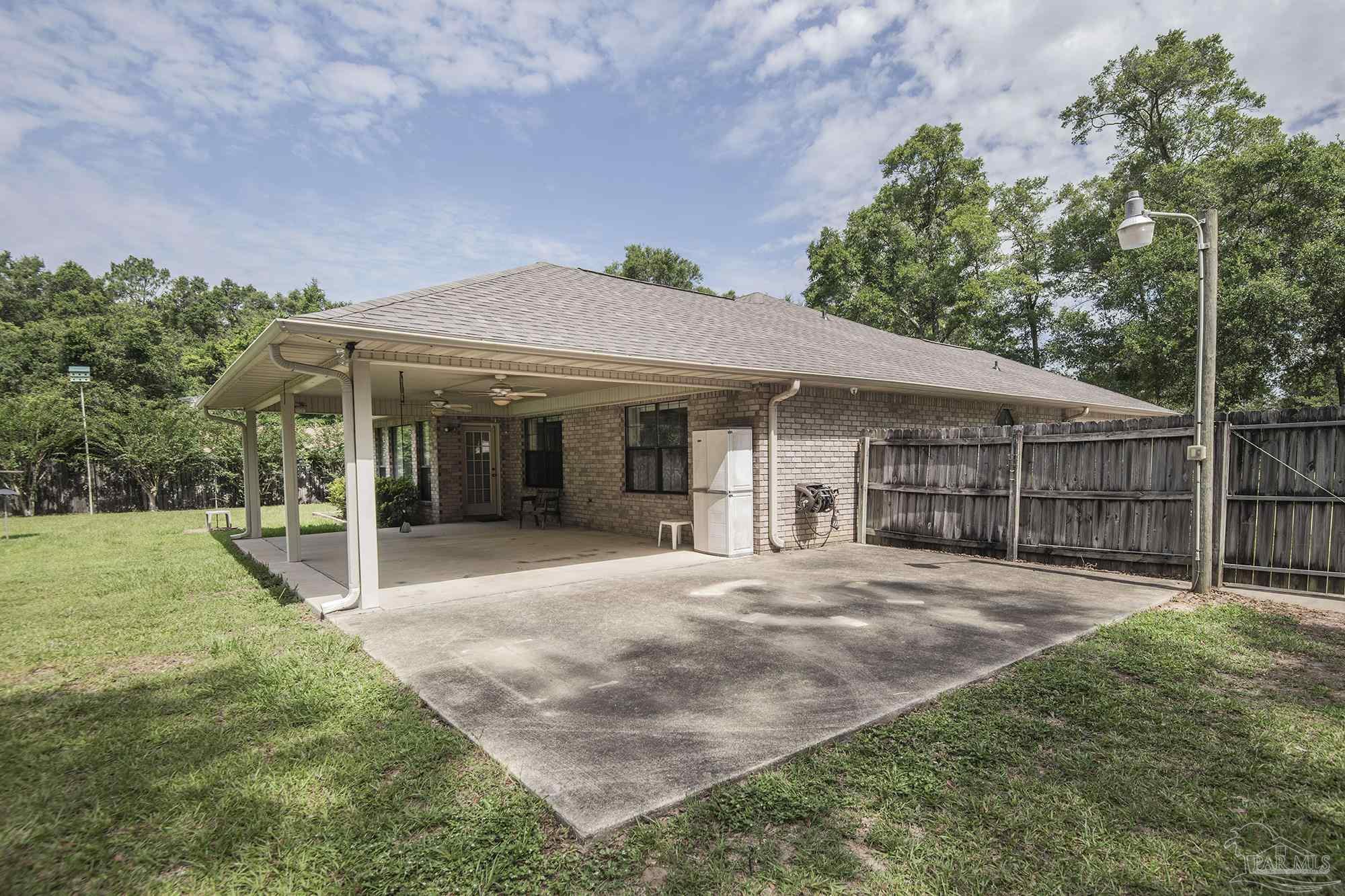 4565 South Spencer Field Road Pace, FL 32571 - Photo 34 of 49 a front view of a house with yard and green space