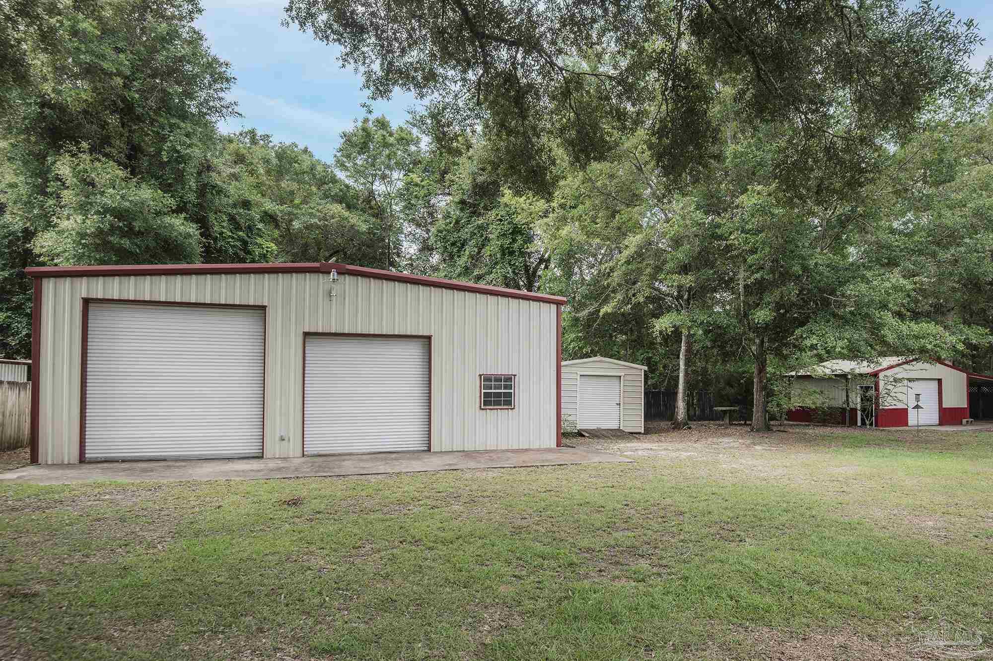 4565 South Spencer Field Road Pace, FL 32571 - Photo 38 of 49 a house with trees in the background