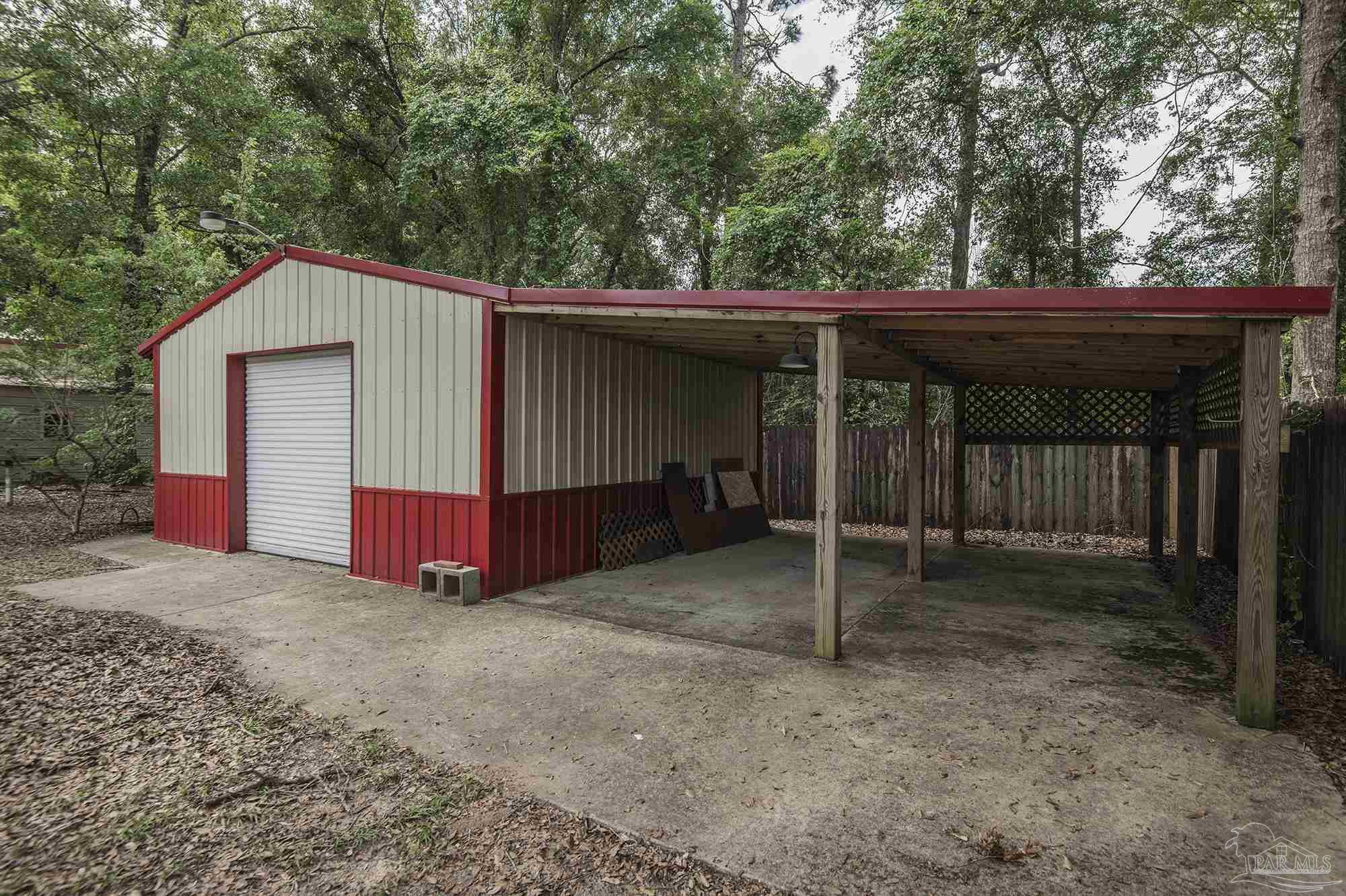 4565 South Spencer Field Road Pace, FL 32571 - Photo 43 of 49 a view of backyard with wooden fence and large trees