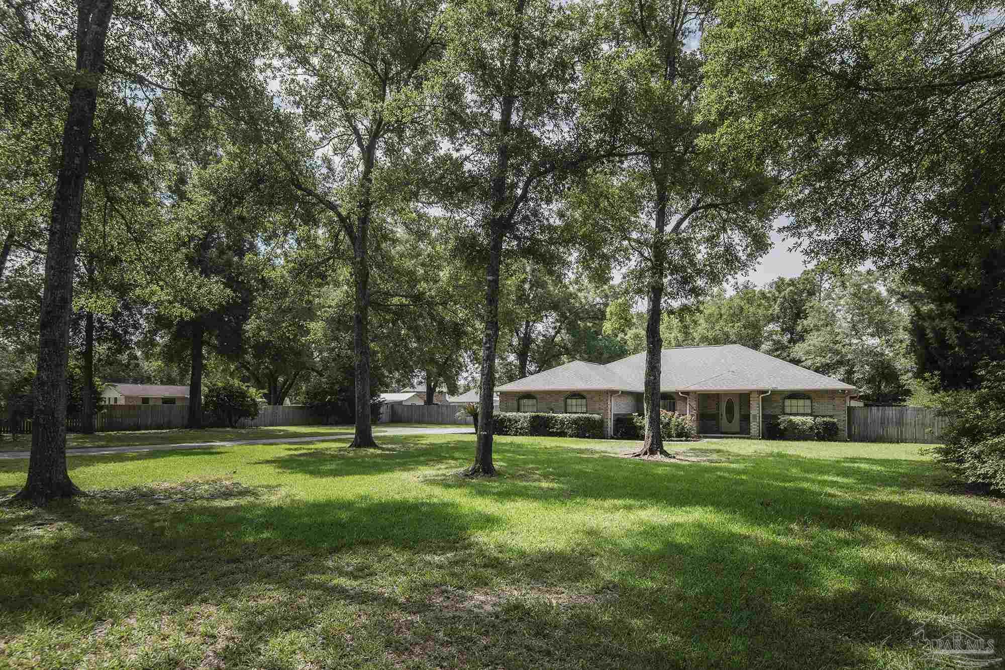 4565 South Spencer Field Road Pace, FL 32571 - Photo 48 of 49 a view of house with garden and trees