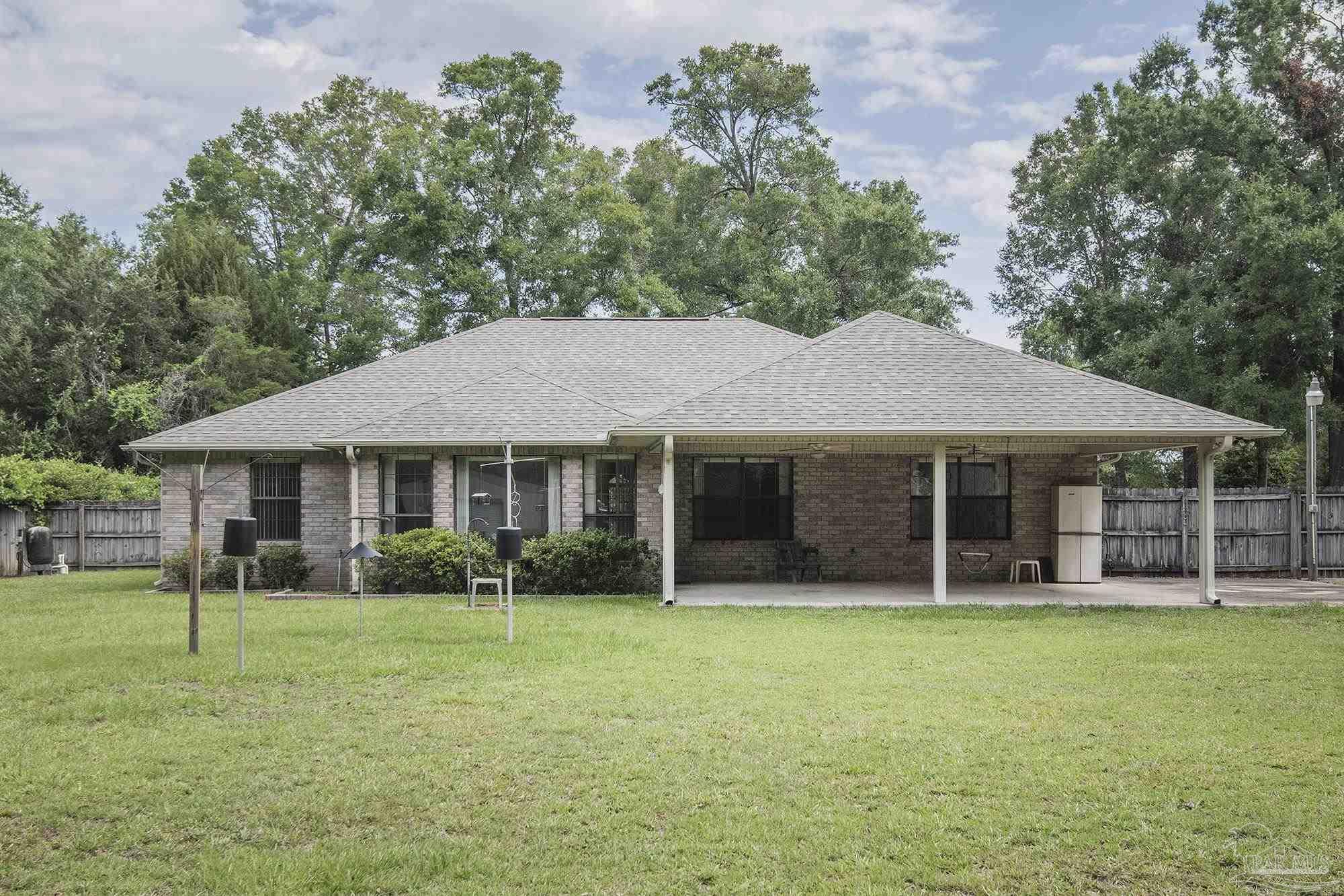 4565 South Spencer Field Road Pace, FL 32571 - Photo 6 of 49 a view of a house with a yard and sitting area