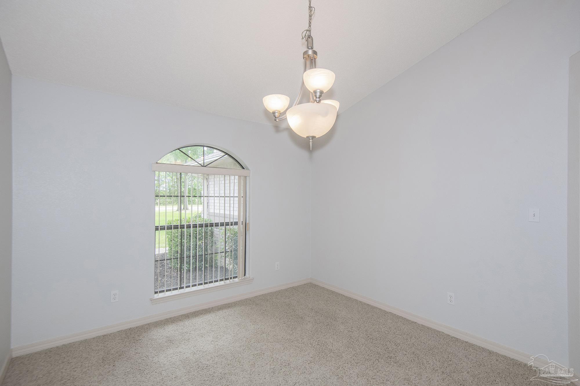 4565 South Spencer Field Road Pace, FL 32571 - Photo 8 of 49 an empty room with windows and chandelier