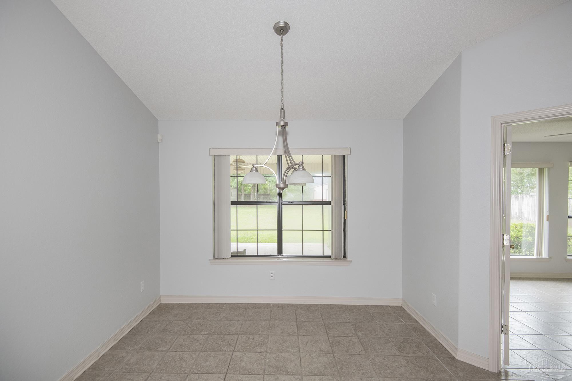 4565 South Spencer Field Road Pace, FL 32571 - Photo 10 of 49 a view of an empty room with windows