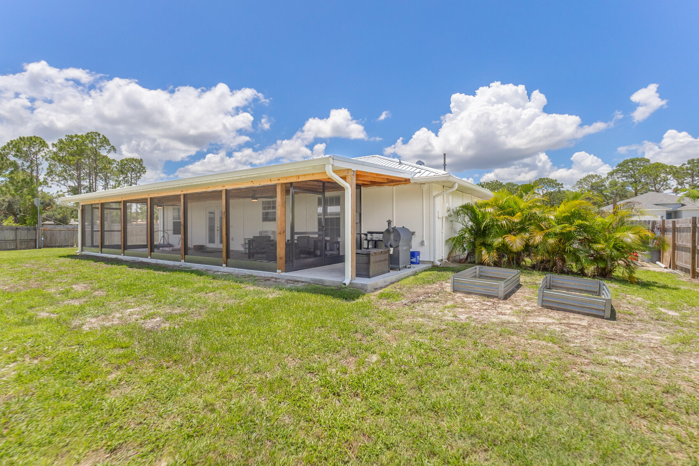 1030 San Rafael Road Southwest Palm Bay, FL 32908 - Photo 27 of 37 a view of a house with a backyard porch and sitting area