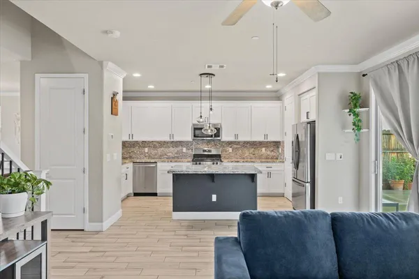a kitchen with stainless steel appliances granite countertop a stove and a refrigerator
