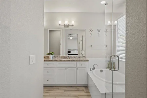 a bathroom with a granite countertop sink vanity and a mirror
