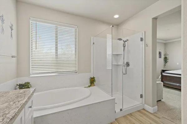 a bedroom with a bed dresser and a window