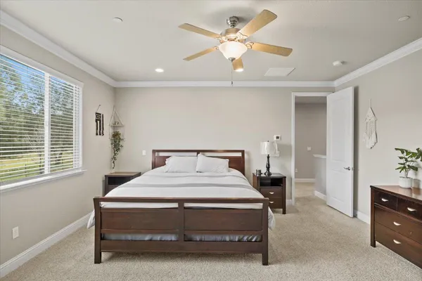 a bedroom with a bed dresser and a window