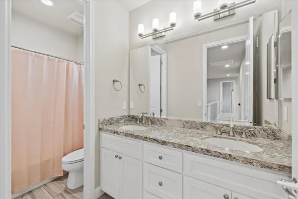 a kitchen with granite countertop a sink stove and cabinets