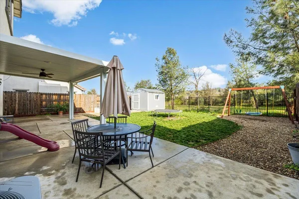a view of a house with backyard porch and sitting area