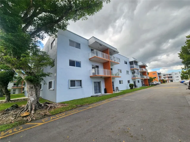 a view of a street with a building in the background