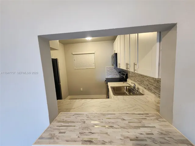 a bathroom with a sink a mirror and shower