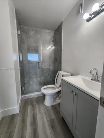 a bathroom with a sink toilet and shower