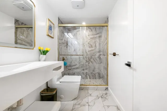 a bathroom with a toilet and a shower