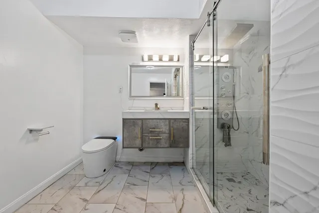 a bathroom with a sink toilet and shower