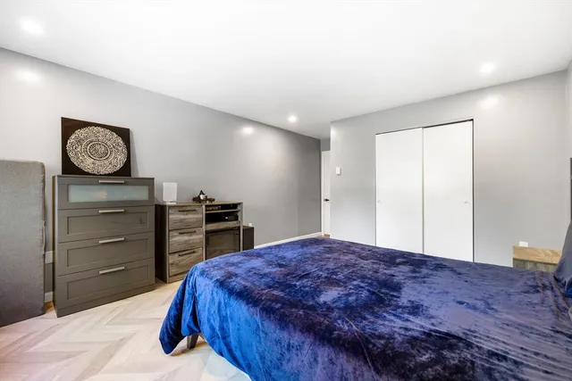 a bedroom with a bed and a closet